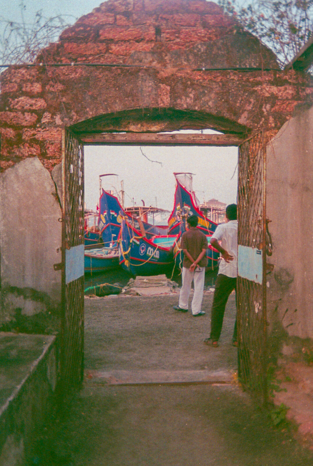 Kochi series — film photograph: heritage doorway and fishing boats