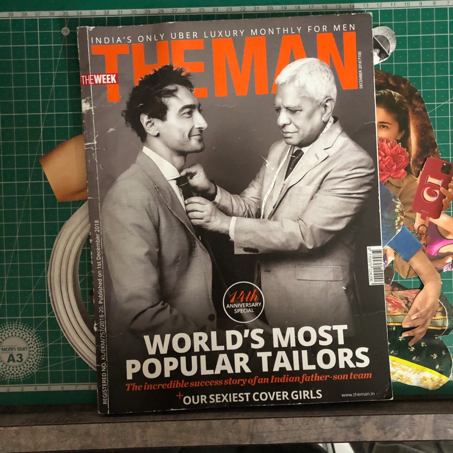 THE MAN magazine, December 2018 cover: an older tailor adjusting the tie of a younger man, headline World's Most Popular Tailors
